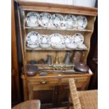 A VICTORIAN STRIPPED PINE DRESSER, with raised shelved back above two drawers and twin doors 52"