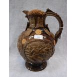 A CASTLE HEDINGHAM 'ESSEX JUG' with moulded battle scenes, coins, shields and other embellishments