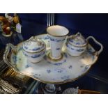 A BLUE FLORAL AND GILT DECORATED DESK STAND with two vase-shaped lidded inkwells and central vase on