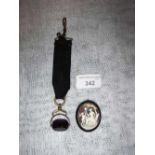 A CAMEO PENDANT and a swivel stone fob attached to a ribbon (2)