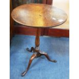 A GEORGE III OAK TIP-TOP TABLE of slender proportions 18" diameter