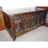 A LARGE 17TH CENTURY COFFER, with earlier carved (possibly French) Gothic panels to the front, the