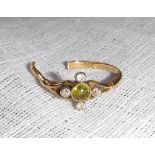 A 'PERIDOT' AND DIAMOND DRESS RING on an 18ct yellow gold shank