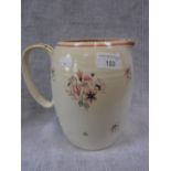 A POOLE POTTERY JUG decorated with pink floral sprays against a cream ground