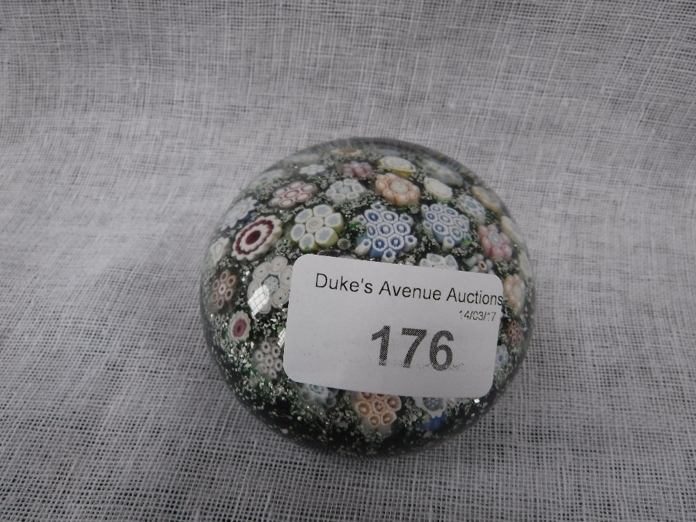 A PAPERWEIGHT with floral canes against a sparkling green ground