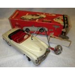 SCHUCO: A CLOCKWORK TIN-PLATE MERCEDES 190 SL with taupe paintwork, with original cardboard box.