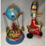 A VINTAGE TIN PLATE DUCK ON A TRICYCLE, made in Western Germany and a similar tin plate 'Swing
