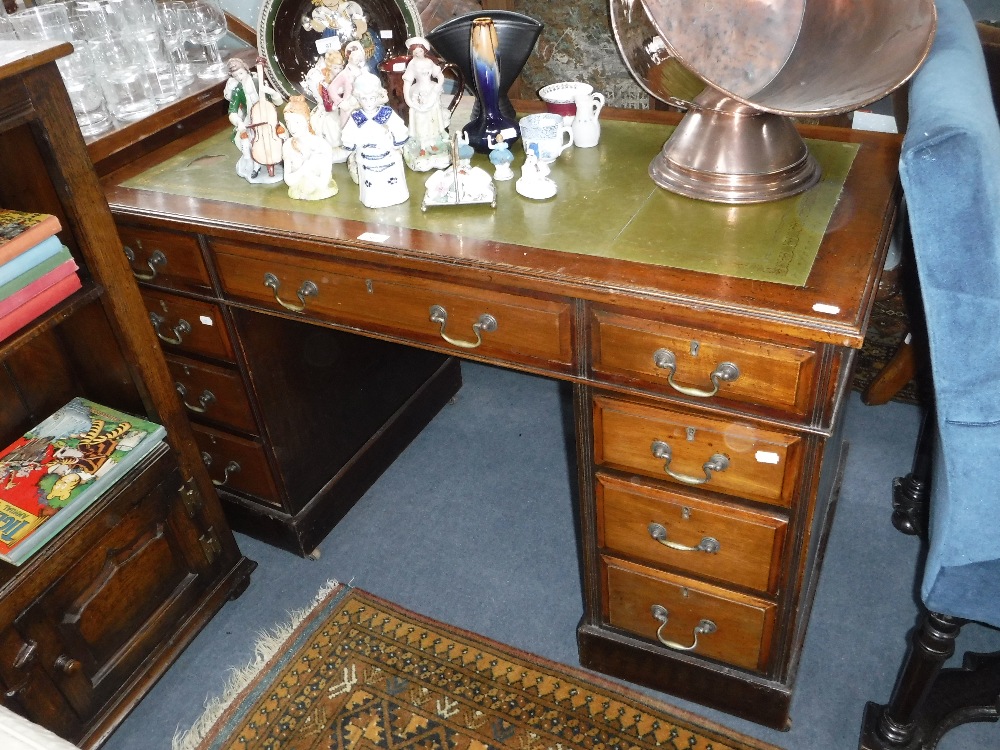 AN EDWARDIAN WALNUT TWIN PEDESTAL DESK with inset green leather top, 46" wide