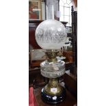 AN EDWARDIAN OIL LAMP, with glass reservoir and frosted shade