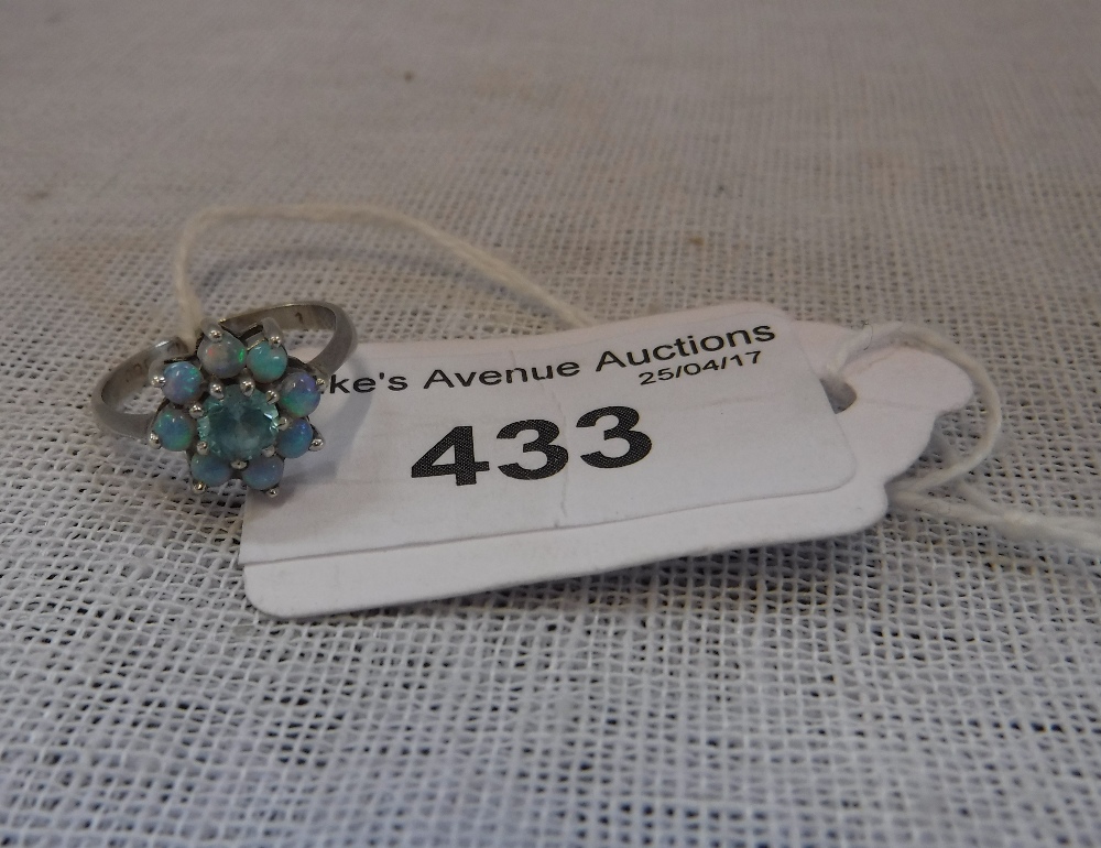 AN OPAL AND BLUE ZIRCON FLOWERHEAD CLUSTER RING in white metal