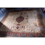 A CREAM GROUND WILTON CARPET with a Persian design 144" long x 126" wide