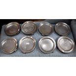 A COLLECTION OF PEWTER WARMING PLATES with twin handles and decorated borders