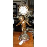 A 19TH CENTURY SPELTER CLOCK in the form of a cherub, on a rouge marble base 15" high