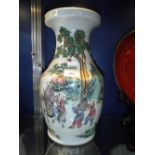 A LARGE CHINESE FAMILLE ROSE VASE decorated with figures carrying a vase and another on horseback