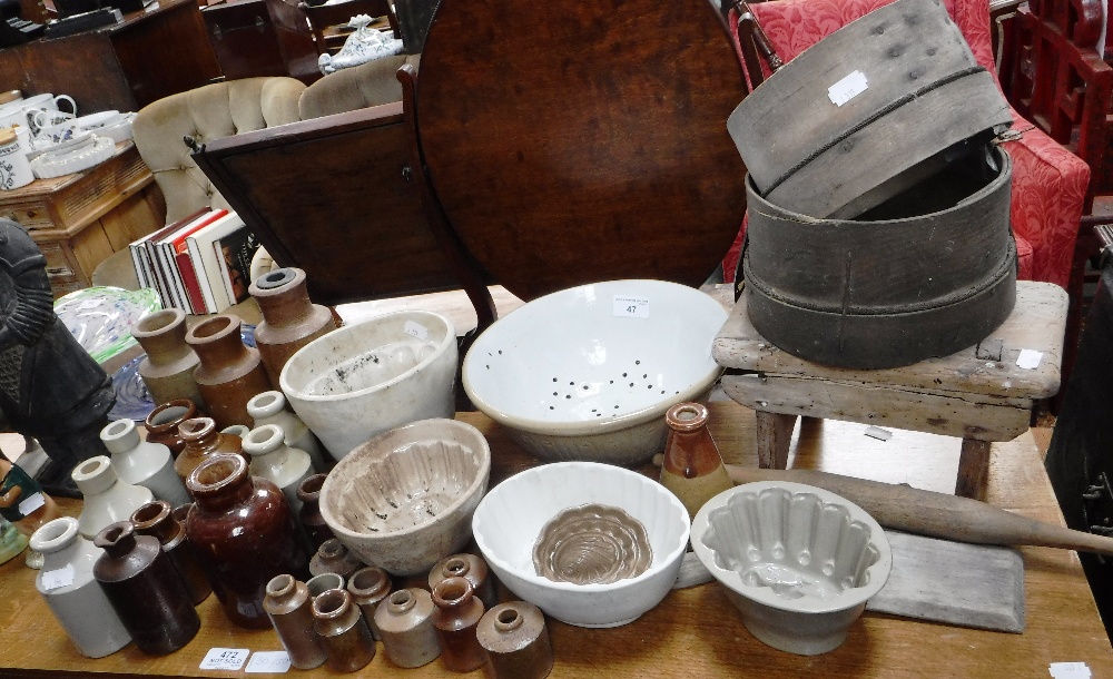 A COLLECTION OF VICTORIAN JELLY MOULDS, stone bottles and kitchenalia