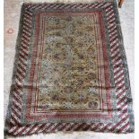 A TRADITIONAL PERSIAN RUG with central yellow panel within a red geometric border 53" long (plus