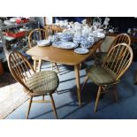 ERCOLL: A PALE ELM AND BEECH DINING TABLE, 32" wide x 57" long (plus extra folding leaf) and six