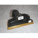 A BRONZE STUDY OF A RECUMBENT SPHINX on gilt base