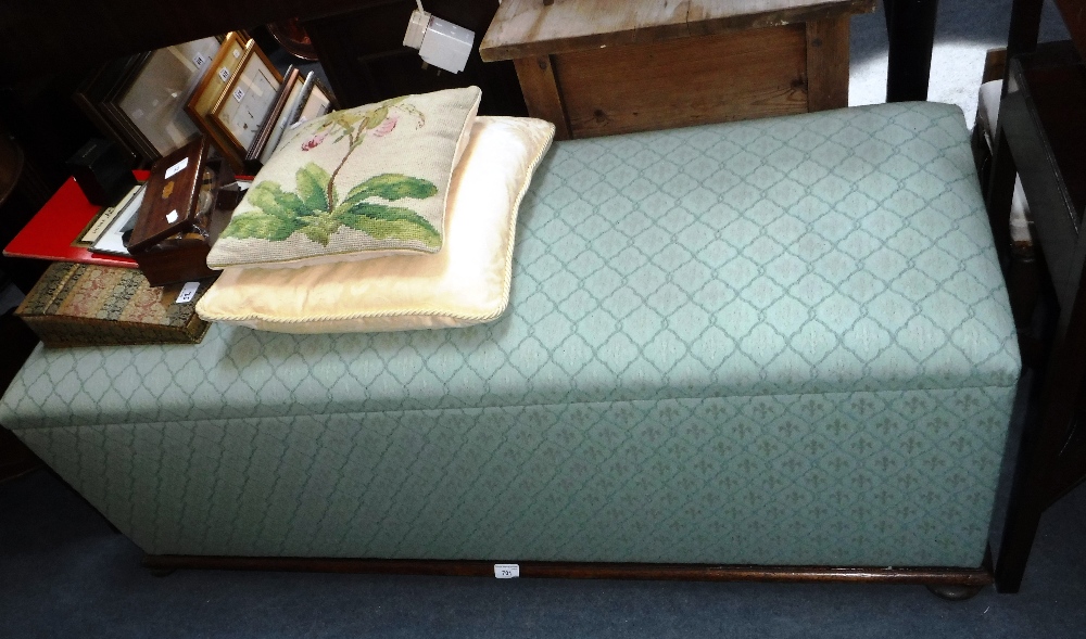 A VICTORIAN OTTOMAN upholstered in green material