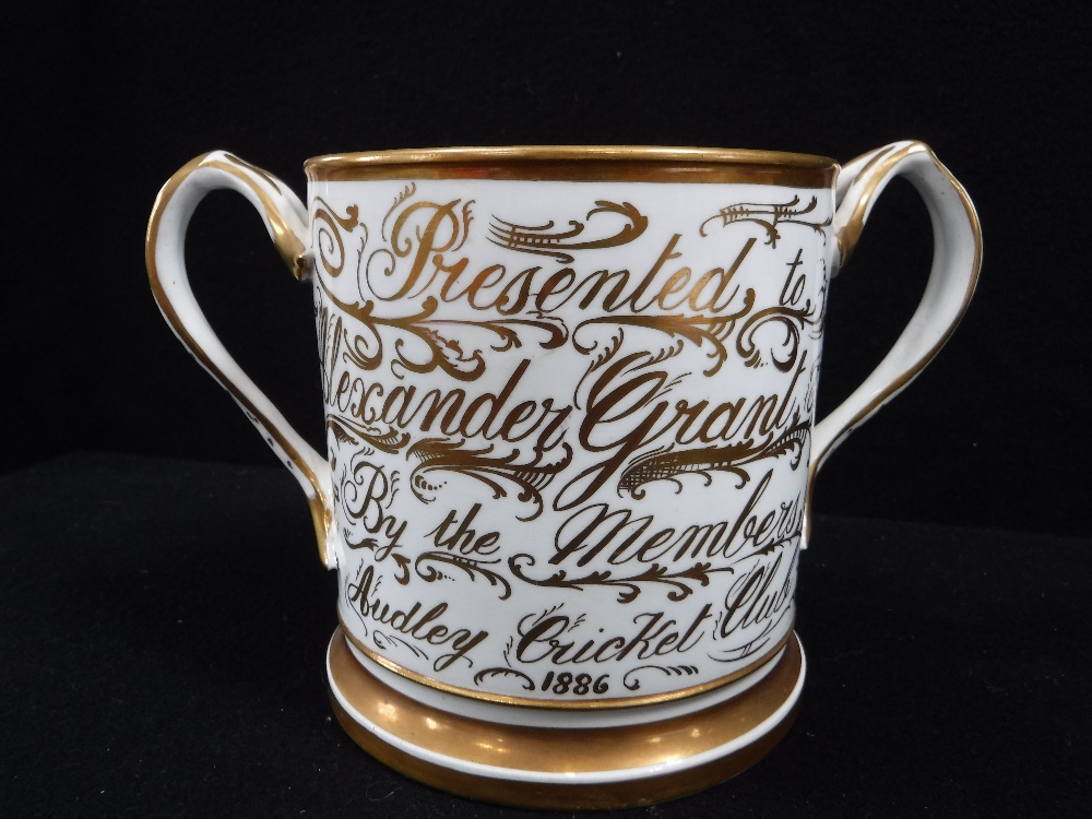 A TWO HANDLED LOVING CUP 'Presented to Alexander Grant, by the Members of Audley Cricket Club 1886'