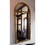 AN EDWARDIAN BEVEL EDGED WALL MIRROR within a gilt ribbon tied frame 36" high x 16" wide