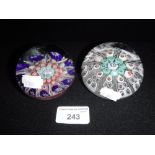 TWO GLASS PAPERWEIGHTS one with radiating and spiral canes and a 'S' cane