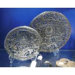 TWO SIMILAR CAST IRON DISHES with all over pierced decoration