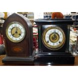 AN EDWARDIAN OAK CASED MANTEL CLOCK and a Victorian iron cased clock (one pendulum and two keys in