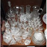 A LARGE CUT GLASS JUG, a collection of drinking glasses and similar glassware