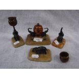 A DESK SET comprising an inkwell with elephant mounts and similar candlesticks and paperweight