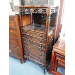 A CHINESE HARDWOOD CABINET with all over carved decoration, fitted seven drawers 47" high x 20"