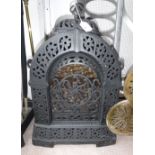 A VICTORIAN CAST-IRON GAS FIRE with pierced decoration and domed lid for kettle stand