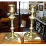 A PAIR OF 19TH CENTURY BRASS CANDLESTICKS with a square base