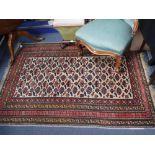 A FINE WOVEN CREAM GROUND PERSIAN RUG with all-over geometric decoration 68" long (plus fringes) x