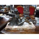 AN ART DECO BRONZE EFFECT SPELTER STUDY OF A YOUNG WOMAN holding a pheasant, on a marble base