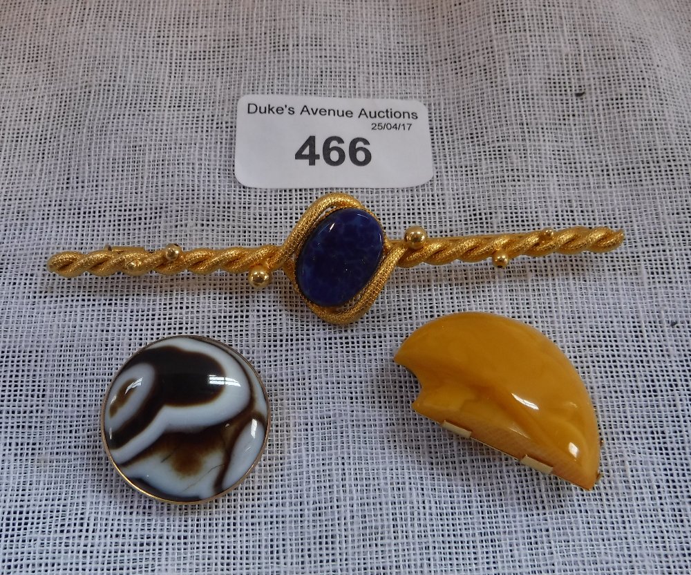 AN AGATE AND GILT METAL CIRCULAR BROOCH, an 'Amber' brooch and another (3)