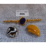 AN AGATE AND GILT METAL CIRCULAR BROOCH, an 'Amber' brooch and another (3)