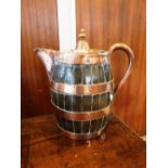 A 19TH CENTURY OAK AND COPPER LIDDED JUG of barrel form, 13" high