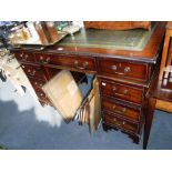 A REPRODUCTION MAHOGANY PEDESTAL DESK with green leather top, 32" high x 48" wide