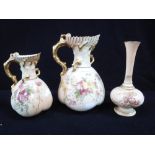 A GRADUATED PAIR OF ROYAL WORCESTER BLUSH IVORY JUGS and a similar vase