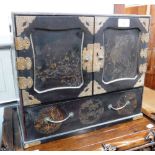 AN EARLY 20TH CENTURY BLACK LACQUER TABLE CABINET with an arrangement of drawers enclosed by two