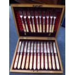 A CASED SET OF IVORY HANDLED FISH KNIVES AND FORKS