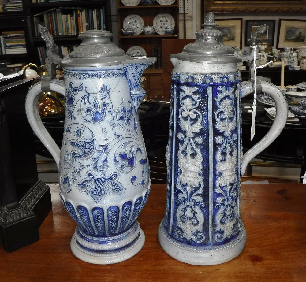 TWO GERMAN STONEWARE STEINS with pewter lids