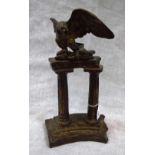 A PATINATED BRONZE STUDY OF AN EAGLE on classical ruined columns 13" high