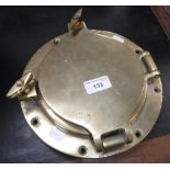 A POLISHED BRASS PORTHOLE by Simpson & Lawrence Glasgow