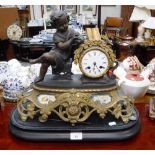 A 19TH CENTURY FRENCH SPELTER MANTEL CLOCK decorated with a study of a girl reading a book (in