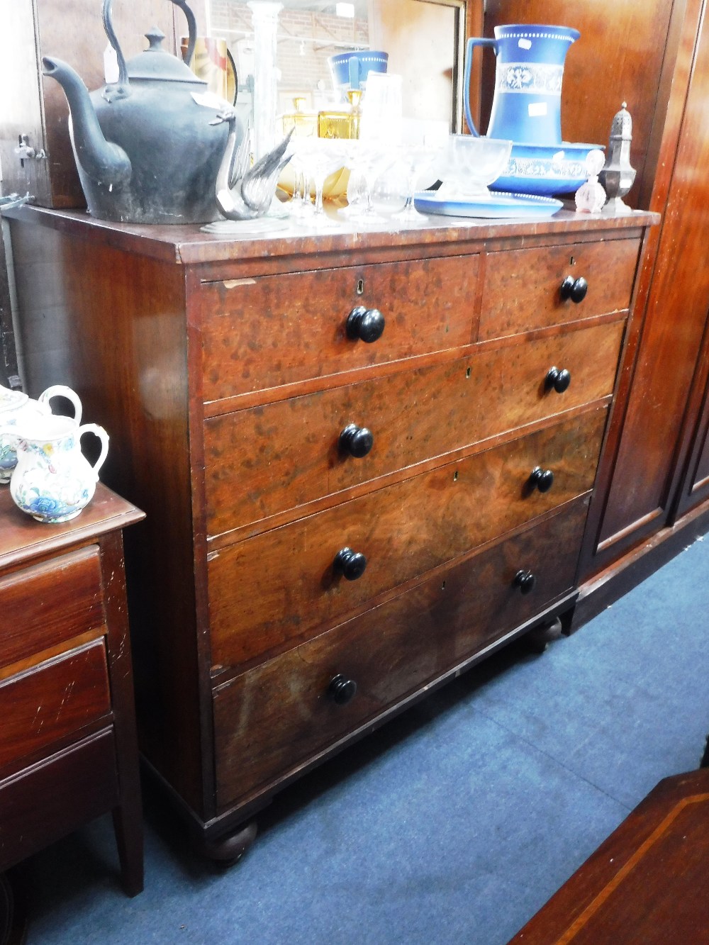 A 19TH CENTURY FIGURED MAHOGANY CHEST OF DRAWERS with ebonised knobs 43.5" high x 46" wide