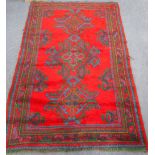 A TRADITIONAL RED GROUND TURKEY RUG 78" long x 51" wide