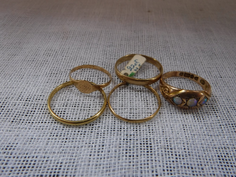 A THREE STONE OPAL GYPSY RING and a collection of other gold rings