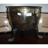 A DUTCH STYLE BRASS JARDINIERE with incised foliate decoration and armorial standing on three paw